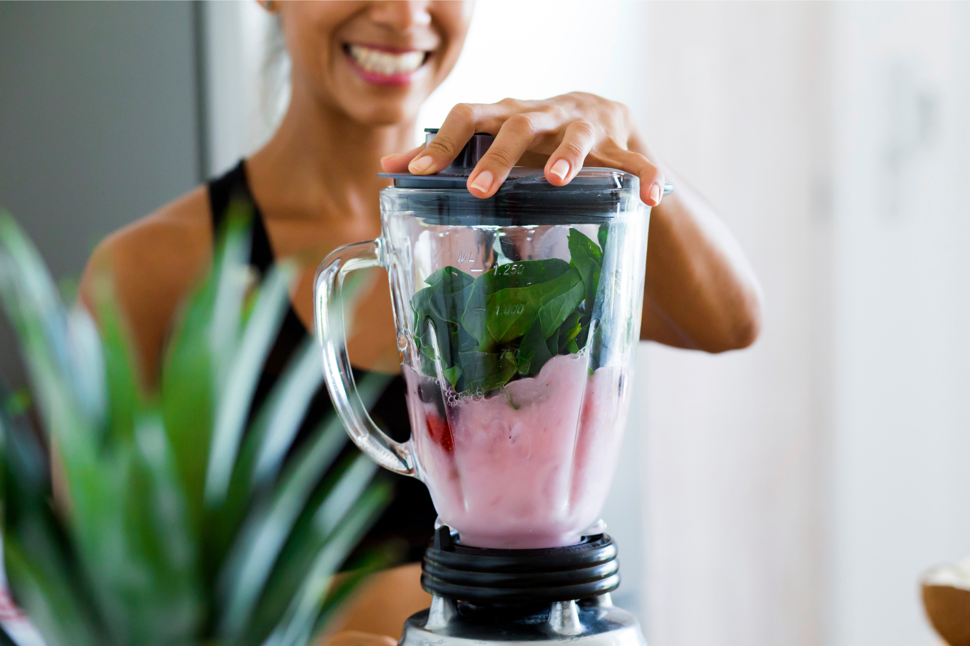 woman preparing a smoothie in a blended